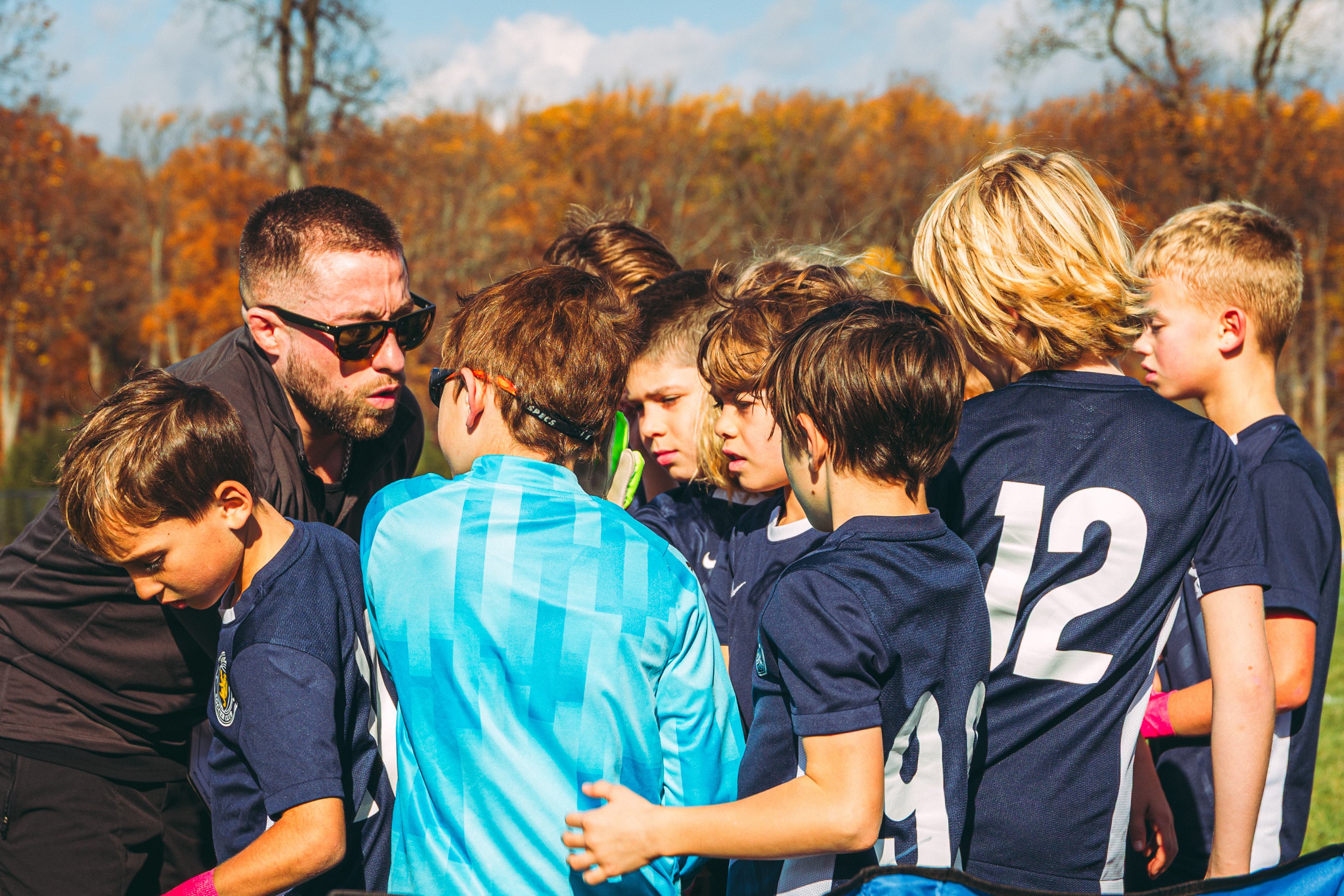 Coach briefing players during a tryouts huddle